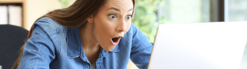 Woman surprised looking at computer